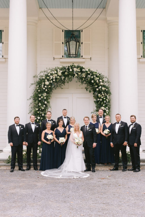 bridal party, blue bridesmaid dress, summer wedding, flower arch, wedding flowers, wedding chapel