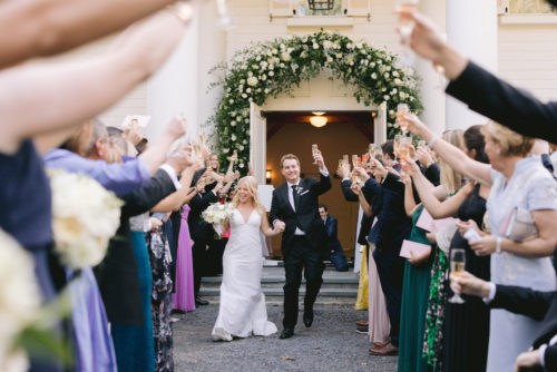 just married, cheers, newlyweds, wedding arch, flower arch, wedding exit, wedding toast