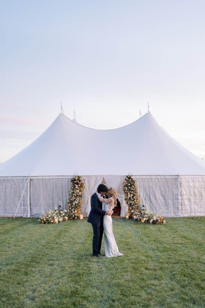 wedding tent, wedding tent entrance, wedding flowers, flower arch, wedding vendors, upscale wedding, luxury wedding, fall wedding, autumn wedding, bride and groom 